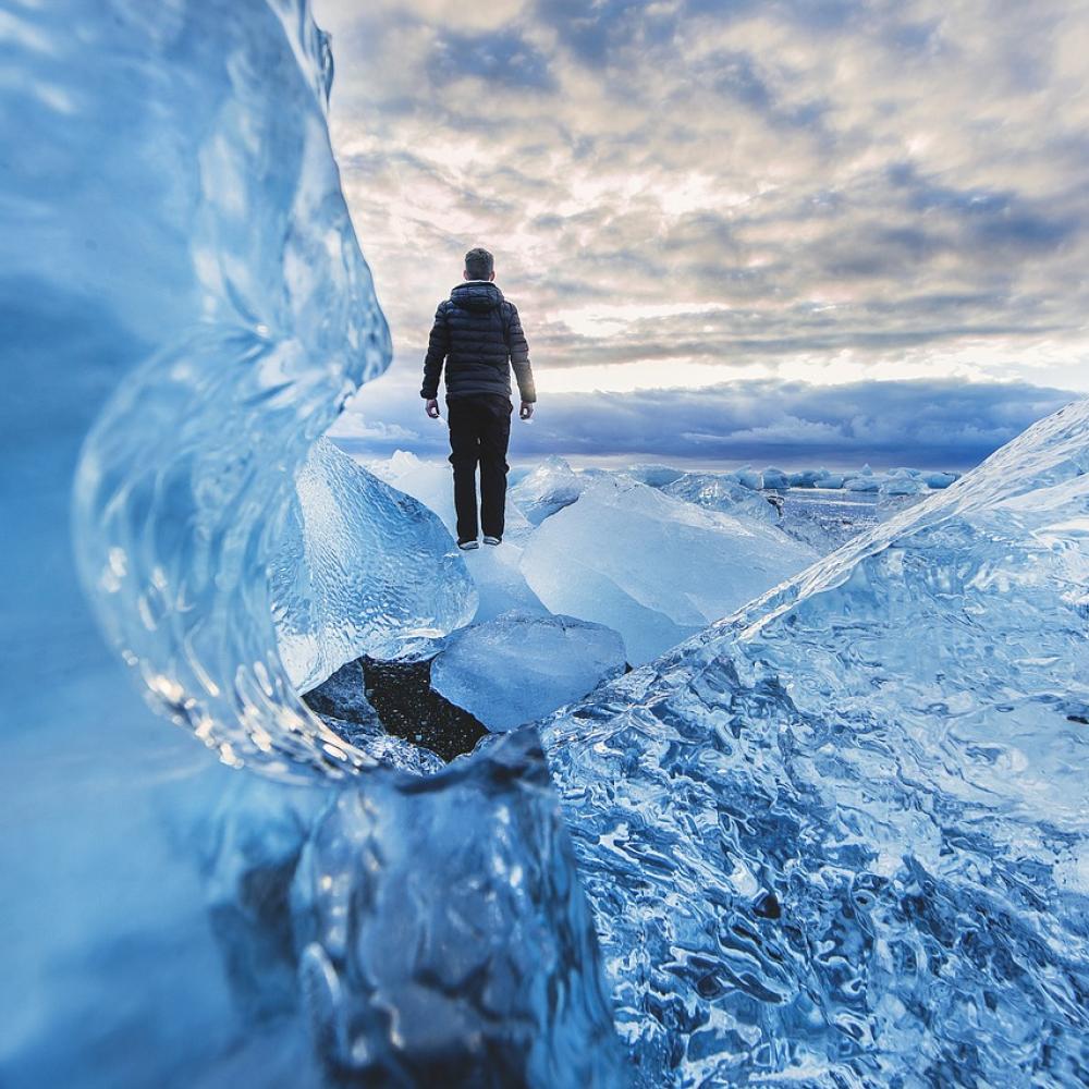 man standing on glacier 