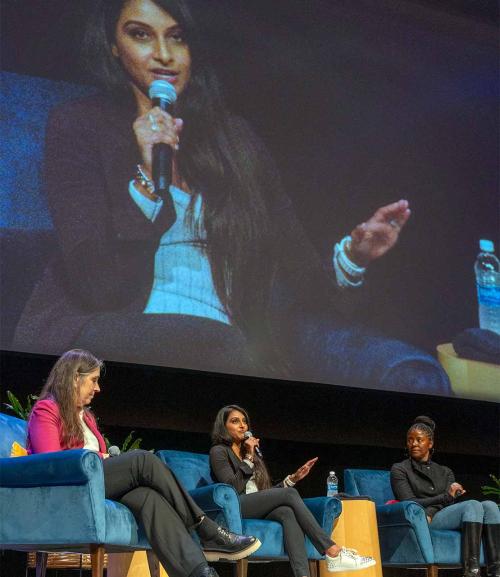 Rinki Sethi ’04 speaks on stage as Kimberly Budil M.S. ’88, Ph.D. ’94 and Victoria Coleman ’08 look on. (José Luis Villegas/UC Davis)