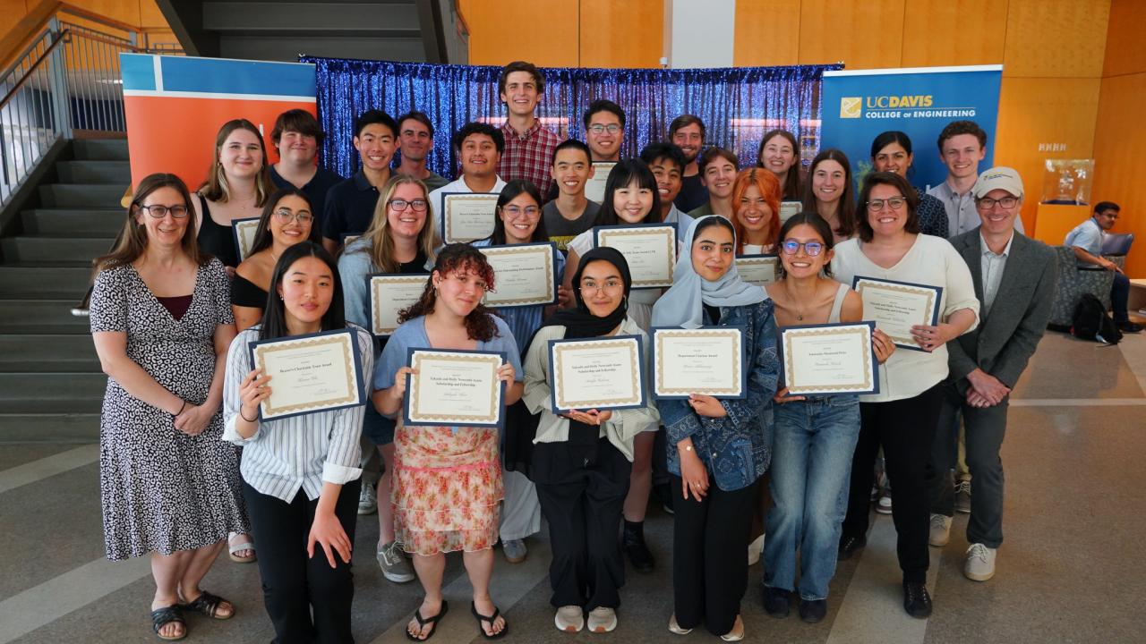 Photo of people standing holding certificates