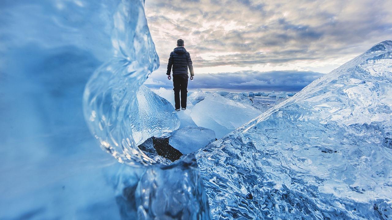 man standing on glacier 