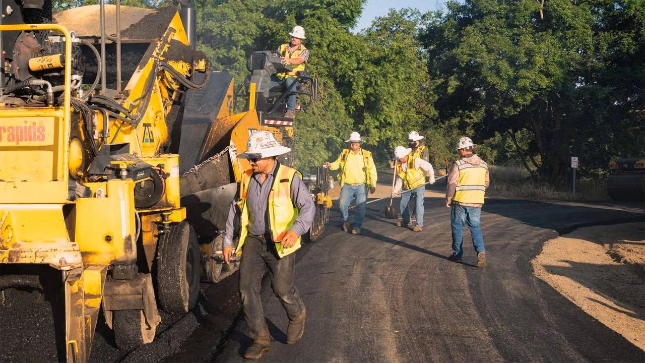 Photo of people paving a road