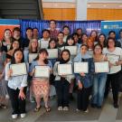 Photo of people standing holding certificates