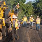 Photo of people paving a road